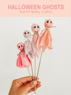 a hand holding up some fake halloween ghost decorations with text overlay that reads, halloween ghosts kid - friendly crafts