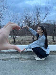 a woman reaching out her hand to touch another person's hand on the street