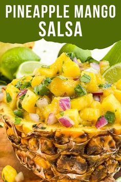 pineapple mango salsa in a pineapple bowl with limes and cilantro