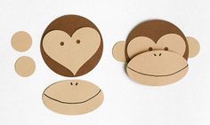 two monkey faces with hearts and bubbles cut out from cardboards on a white surface