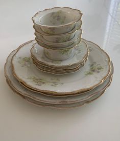 a stack of plates sitting on top of a white countertop next to each other