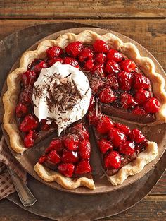 a chocolate pie topped with cherries and whipped cream