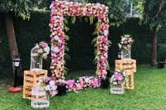 an outdoor ceremony setup with flowers and birdcages