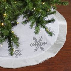 a christmas tree skirt with snowflakes on it