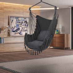 a grey hammock chair hanging in a living room