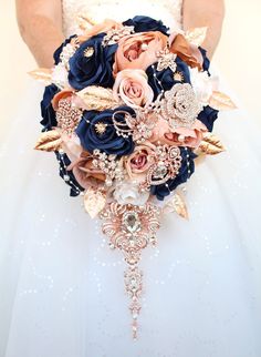 the bride's bouquet is made up of blue and peach flowers, brooches, pearls, and leaves