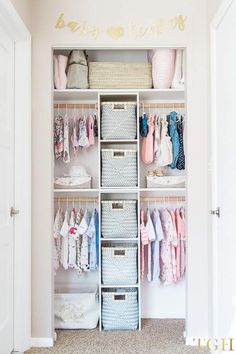 an organized closet with baby clothes and baskets