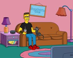 a man sitting on a couch with a cat in his lap