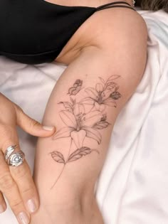 a woman with a flower tattoo on her arm