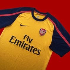 a yellow and blue soccer jersey with the word fly emirates on it's chest