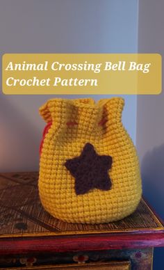 an animal crossing bell bag crochet pattern on top of a chest with the words animal crossing bell bag written across it