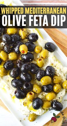 a white plate topped with olives and rice