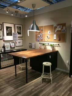 a kitchen with an island and stools next to it in the middle of a room