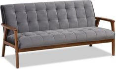 a gray couch sitting on top of a wooden frame