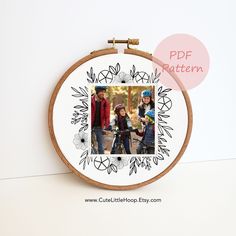 an embroidery hoop with a picture of two children on it and the words pde pattern