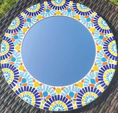 a circular mirror sitting on top of a wicker table