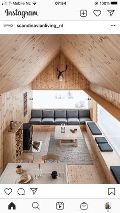 a living room filled with furniture and wooden walls