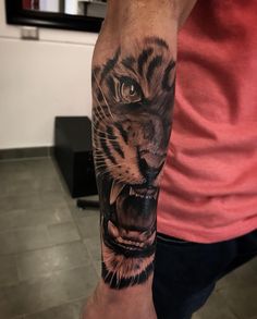 a man with a tiger tattoo on his arm