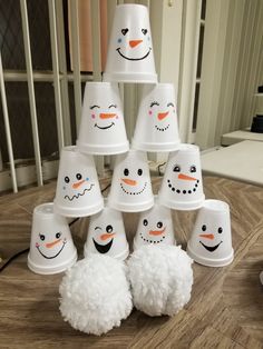 a group of snowmen sitting on top of a wooden table