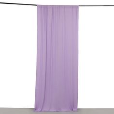 a purple curtain is hanging on a clothes line