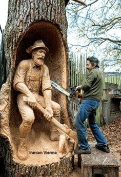 a man standing next to a carved tree