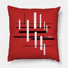 a red pillow with black and white lines on it