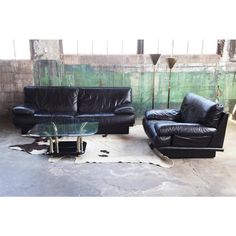 two black leather couches sitting next to each other