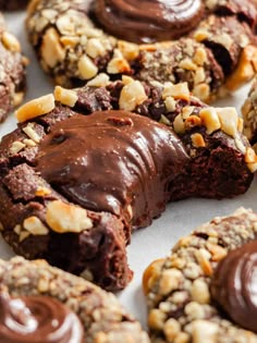 chocolate covered cookies with nuts and nutellas on the top are ready to be eaten