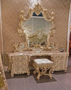 an ornately decorated dressing table with mirror and stool