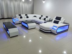 a white and black couch with blue lights on the backrests in a room