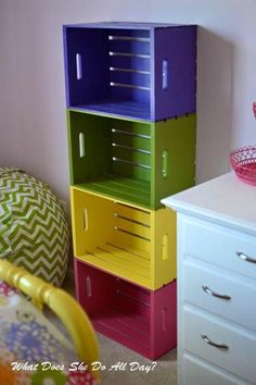 a stack of colorful boxes sitting on top of a white dresser