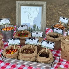 there are many bags full of food on the table and some signs in front of them