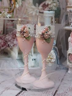 two wine glasses with flowers and pearls on them