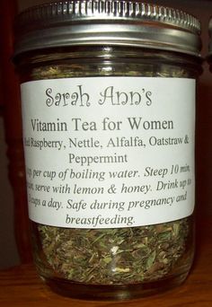 a jar filled with herbs sitting on top of a wooden table