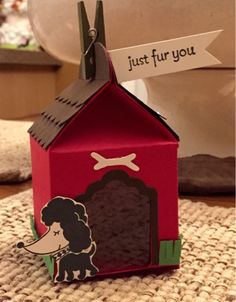 a red doghouse with a sign that says just fur you on the front and side