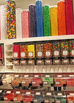 the shelves are filled with many different types of candies