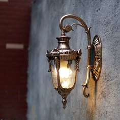 an old fashioned street light on the side of a building