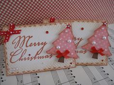 two pink christmas trees on top of sheet music