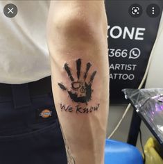 a man with a tattoo on his arm that reads we know and has a hand print