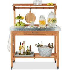 a kitchen island with bottles and glasses on it next to a potted lemons