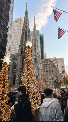 people are standing in front of a christmas tree