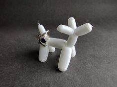 a white balloon dog with a ring on it's head