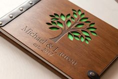 a personalized wooden notebook with the name and date engraved on it's cover