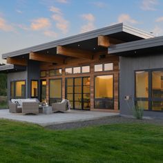 a modern house with large windows and lots of grass