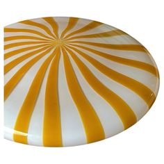 a yellow and white striped plate on a white background