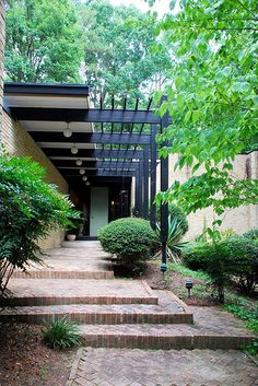 an outdoor walkway with steps leading up to the front door