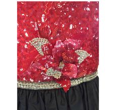 This exquisite dress has an intricately sequined and embroidered bodice and a full black silk skirt. The bodice has a crewneck and is sleeveless and has three dimensional red sequined flowers and clear beads. If you look closely you can see there's even silk embroidery accenting the areas. The neckline and waistline are trimmed with clear bugle beads. The closure in the back is a zipper with the hook and eye and the label is on the shoulder. The skirt is in excellent condition. The size is appro Red Silk Sequined Dress, Red Silk Dress With Sequins, Silk Sequin Party Dress, Red Party Dress With Sequins, Silk Sequined Dresses For Party Wear, Red Party Wear Dress With Sequins, Red Sequin Party Dress, Red Party Wear Gown For Party, Black Silk Skirt