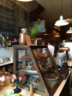 a display case in a bakery filled with lots of food