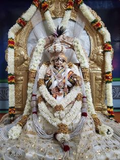 the statue is decorated with flowers and garlands