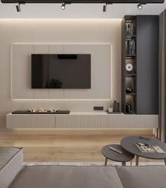 a living room with a couch, coffee table and television on the wall in front of it